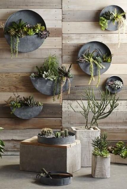 round zinc planters attached to the wall is a cool space-saving idea