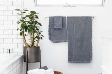 13 a wicker basket with towels adds a luxurious touch to the bathroom