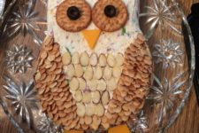 13 an owl cheese ball with crackers for eyes and slivered almonds for feathers