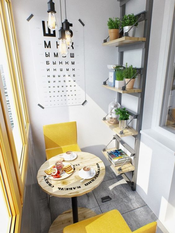 a modern industrial breakfast space with yellow chairs and an industrial spool table