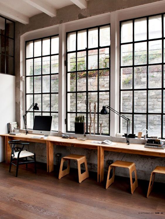 an industrial space with a windowsill turned into a long desk
