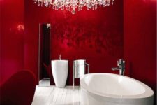 16 bloody red bathroom with a white floor and bathtub and an oversized crystal chandelier
