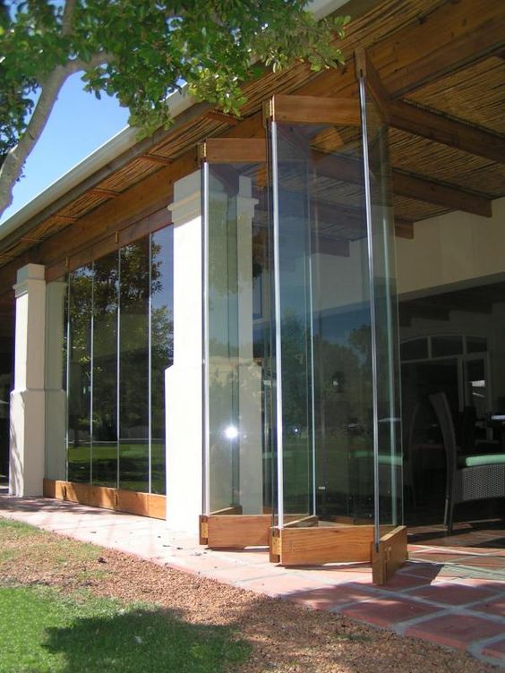 this frameless folding door seems to disappear in the air leaving no boundaries betwene indoors and outdoors