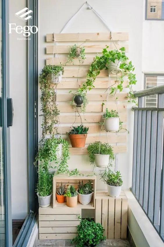 a planked hanging with potted greenery is a cool idea for any small balcony, it’s an easy way to refresh the space