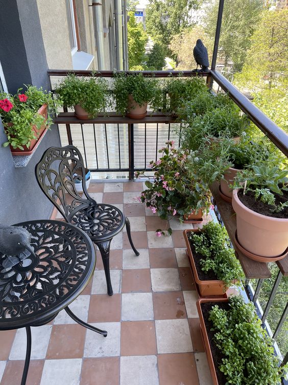 a shelf with potted greenery and planters on the floor are a cool combo for a small balcony