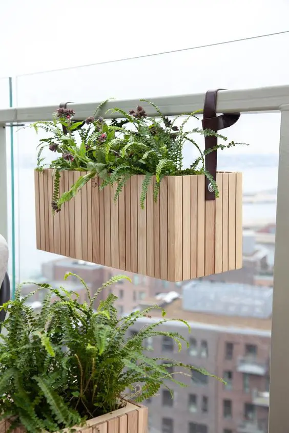 a stylish modern hanging planter with blooms and leather pulls is a cool and chic idea for a modern space