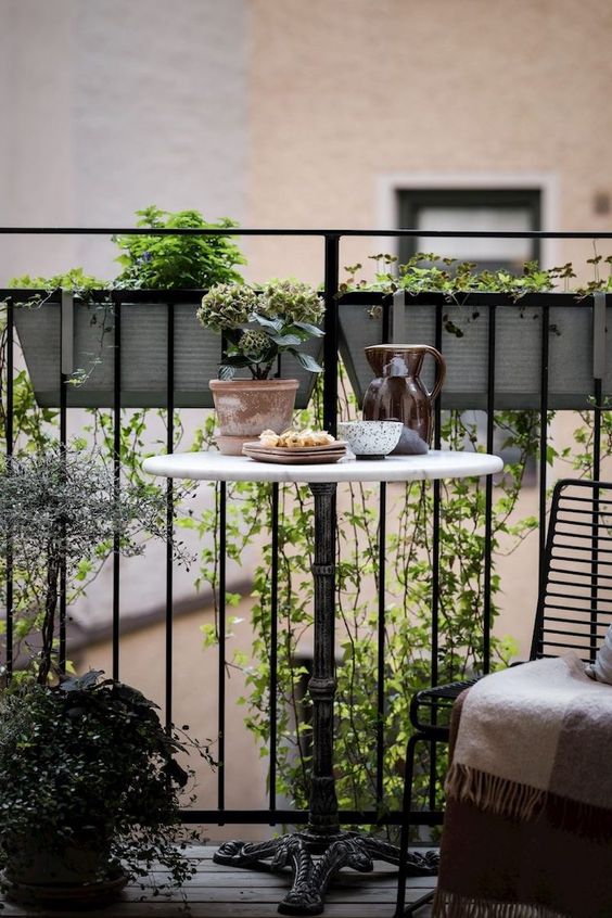 metal planters hanging on the other side of the railing are great to make your space fresh without wasting it
