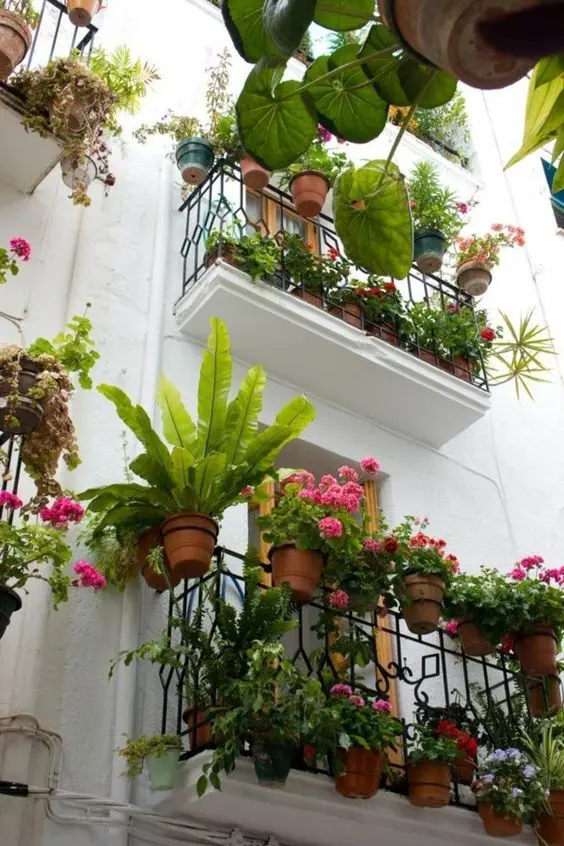 railing planters with blooms and greenery are great to style any balcony, even a small one, in a fresh and cool way
