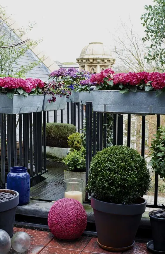 stainless steel planters attached to the railings and some usual planters on the floor make the space fresher and cooler