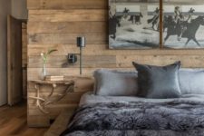 02 a rustic bedroom completely covered with wood planks, with a wooden platform instead of a bed and faux fur