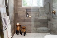 02 an elegant shower space with wood-looking tiles on the walls and a built-in shelf