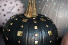 03 a black matte pumpkin with gold studs is a chic and easy DIY for this Halloween