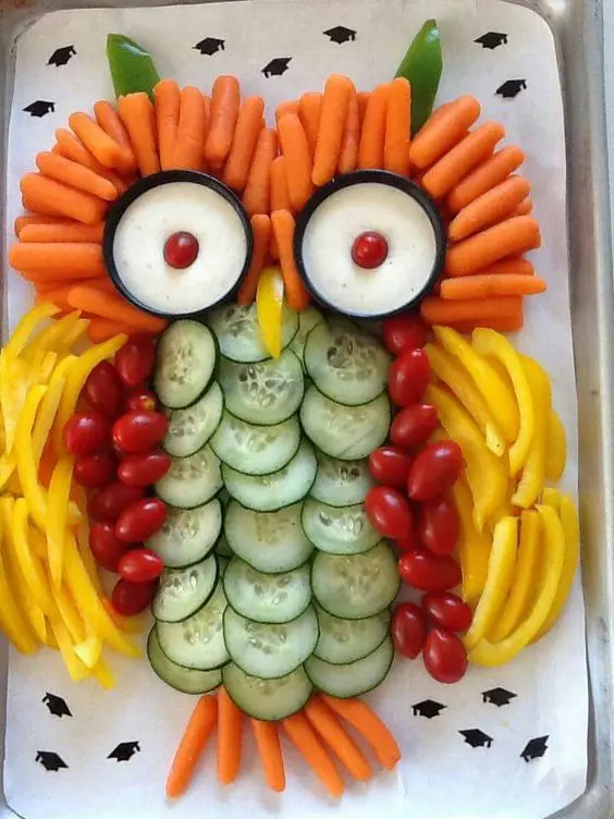 a fun veggie tray shaped as an owl and sauce bowls as eyes is a chic and fun idea