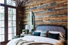 04 a rustic and chalet-inspired retreat with walls and ceiling covered with reclaimed wood and a metal chandelier