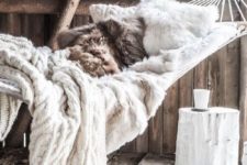 04 faux fur pillows and knit blankets make this hammock super inviting for the flal and winter