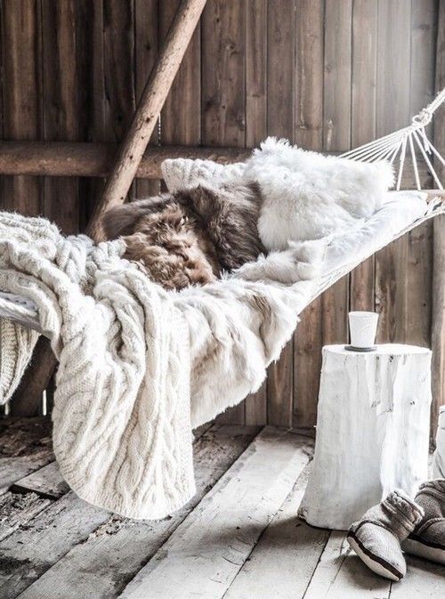 faux fur pillows and knit blankets make this hammock super inviting for the flal and winter
