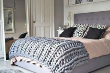 05 a grey chunky knit blanket and a faux fur rug make the space comfier and add a textural look