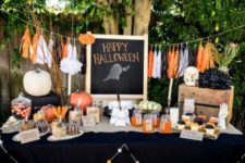 05 traditional black and orange decor with a fabric banner, pumpkins and skulls