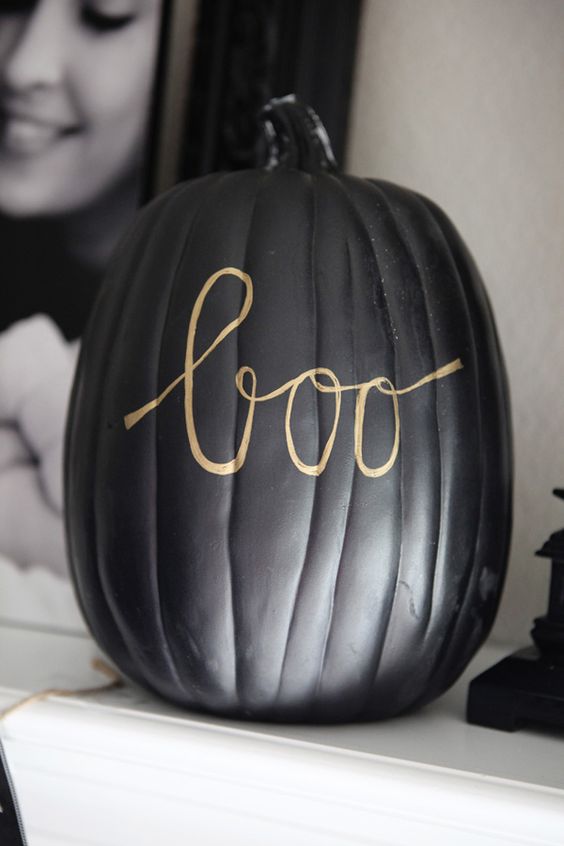 decorate a matte black pumpkin with a simple gold pen writing whatever you like