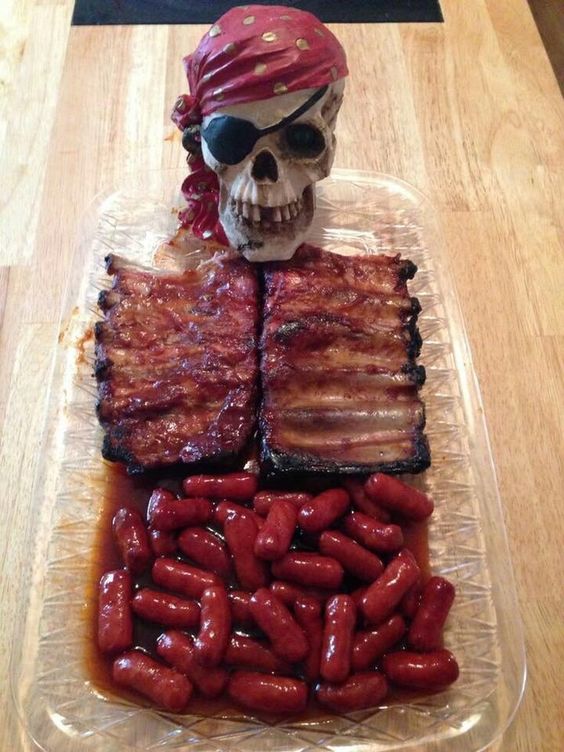 sausage and ribs display with a skull for a pirate-themed Halloween party