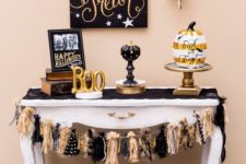 10 a chic cake table with glam black and gold pumpkins, a pallet sign and a cool garland