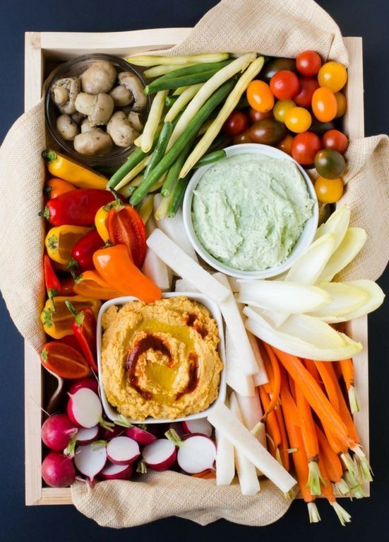 a cool tray with fresh vegetables and several kinds of dip looks rustic and heirloom styled