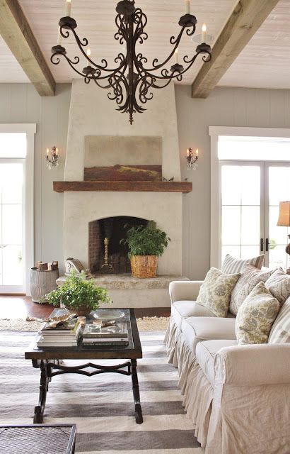 stucco walls and a fireplace for a rustic vintage space, and wooden beams to add coziness