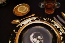 13 a stylish place setting with a skull print plate, a gold charger and cutlery