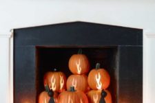 14 If you’re always thinking you don’t use your fireplace enough, this fun decoration was made for you. Carve flames into pumpkins for a cozy atmosphere