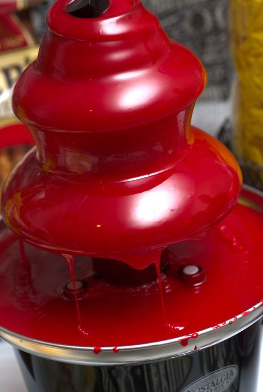 a chocolate fountain with red tinted chocolate will strike every guest at the party