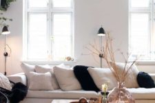 14 a neutral faux fur rug and black faux fur pillows to cozy up the living room