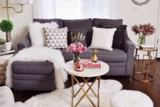 a chic faux fur rug and a matching blanket and pillow turn this space into a glam winter one