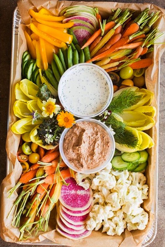 organic fresh veggies platter with two kinds of dip in bowls looks very stylish