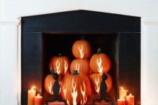 02 a fireplace with antler carved pumpkins and black cants and candles around