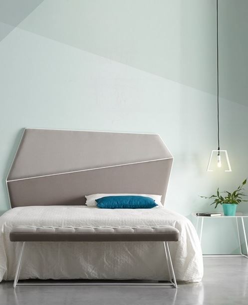 a minimalist geometric upholstered headboard in two shades of grey