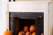 04 a stylish pumpkin display in the fireplace, all pumpkins are painted differently
