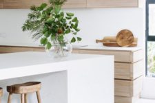 06 a light-colored wood kitchen is made more modern with a white kitchen island and white countertops