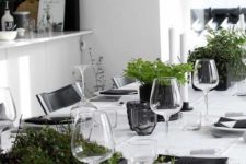 06 a minimalist tablescape in black and white with potted fresh greenery looks very chic