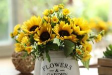 06 a sunflower arrangement in a vintage bucket looks simple and farmhouse-like