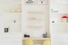 08 a modern and playful space done in creamy white with shelves, drawers and two curved chairs for the little ones