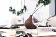 08 a modern fall look with black placemats, eucalyptus, a faux fur table runner and white pumpkins is simple to recreate