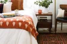 08 add a touch of fall shades with an burnt orange printed bedspread and a printed pillow