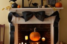 09 a stylish display with a pumpkin and candles and a large bow over it