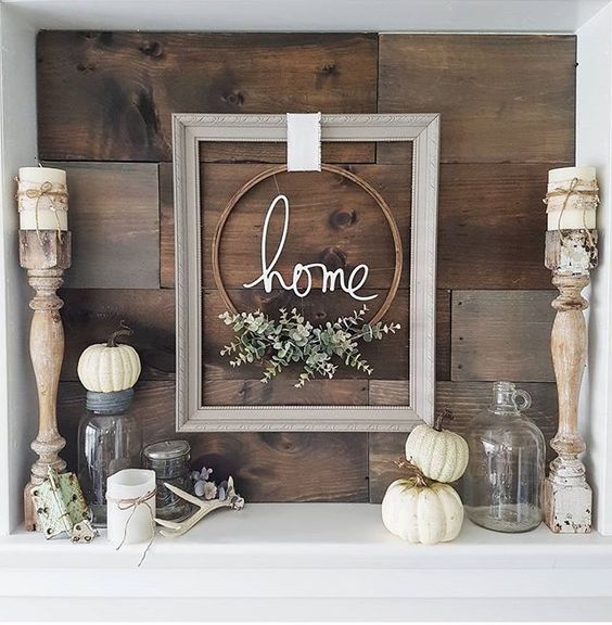 a cool frame and embroidery hoop wreath, some pumpkins, antlers and candles for a modern rustic space