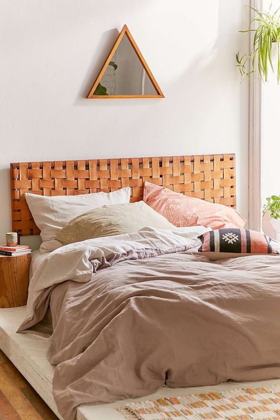 a boho-inspired space with a woven leather headboard looks cool