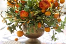 11 a lush centerpiece with citrus and orange blooms for a cool Thanksgiving table