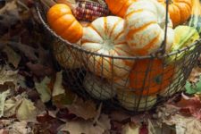 11 a metal basket with pumpkins, gourds and corn is a simple display that screams harvest