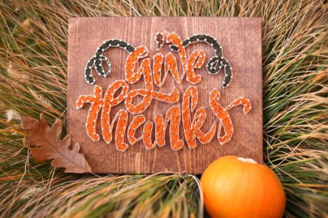 a cool sign with 'Give thanks' and greenery touches