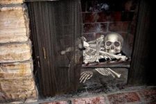 12 a human skeleton and a skull inside a fireplace is a scary idea for Halloween