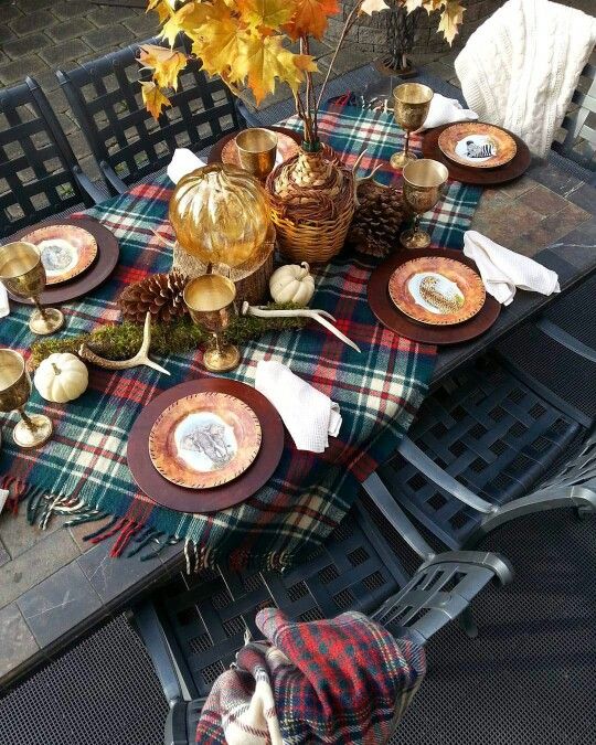 a plaid shawl used as a tablecloth for Thanksgiving, moss and antlers over it
